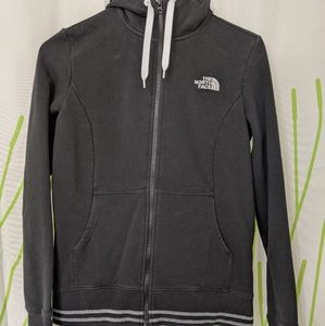 North face size small black zip up white stripes